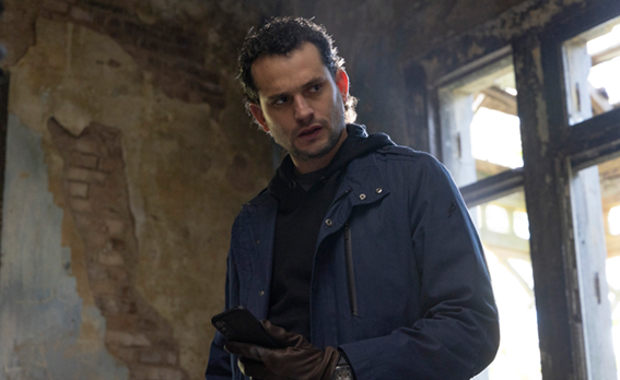 A person in a dark jacket and gloves holding a phoneAI-generated content may be incorrect.