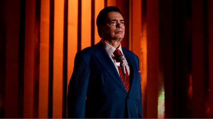 Homem em pé com terno e gravataO conteúdo gerado por IA pode estar incorreto.