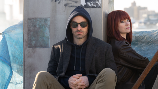 A person and person sitting on a stone wallAI-generated content may be incorrect.
